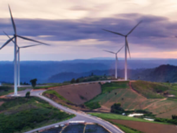 Wind turbines in countryside at sunset, generating clean energy for a sustainable future
