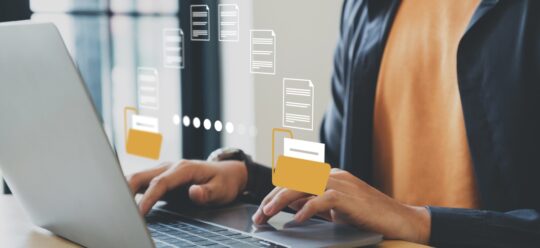 Someone typing on a laptop