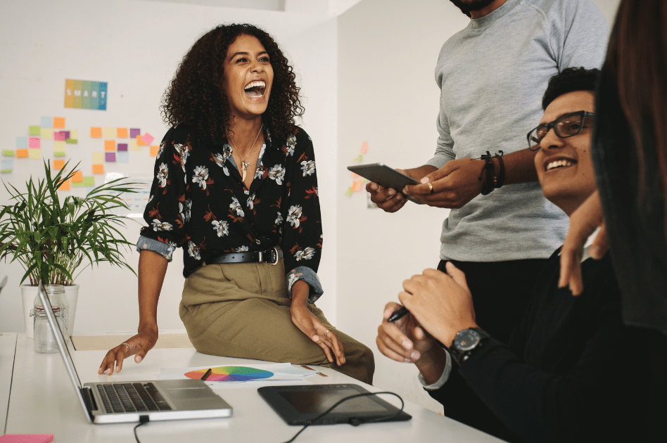 Four colleagues having a chat at their desk