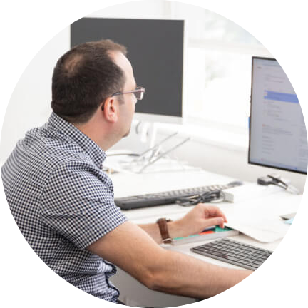 Enhance Media employee at his desk